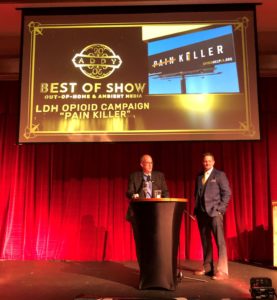 Feigley Communications President Stuart Feigley and Art Director Ben Benton accept the Best of Show award for Out-of-Home and Ambient Media at the 2020 American Advertising Federation's Addys ceremony. 