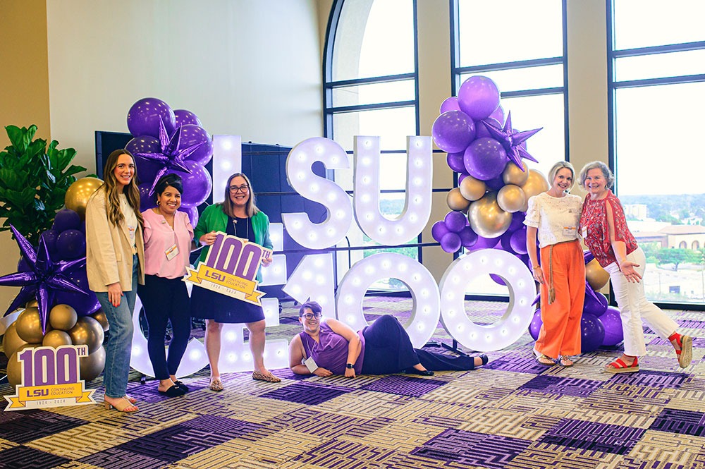 Guests enjoying the photobooth and Feigley-created props at the 100th celebration. Photo by: Rebecca Warren